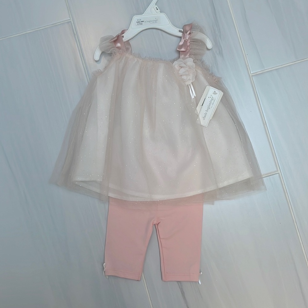 Soft pink tulle dress with white lining and pink pants.  Size 9 months